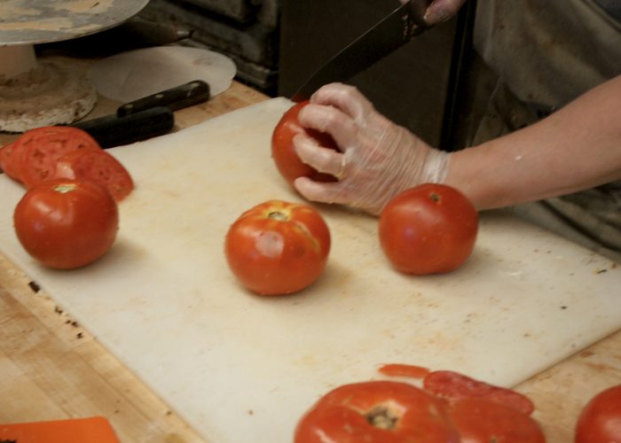 Slicing tomatoes.